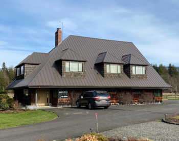 House with a new metal roof installed by Topside Roofing & Siding in Whatcom County, WA.